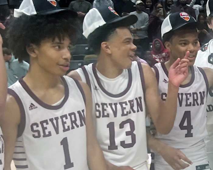 Severn's Corey Dixon (13) shares a laugh with teammates Daniel Growney (left) and Kinston Price after Saturday's MIAA B Conference championship game Saturday at UMBC. Dixon, the son of former Maryland All-American and NBA player Juan Dixon, played a major role this season as a freshman for the Admirals who won their first title in 31 years.